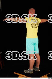 Whole body yellow shirt turquoise shorts brown shoes modeling t…